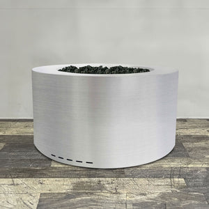 Front view of 36" Round Gravity Stainless Steel Fire Pit by Starfire Designs - Brown with flames on, featuring sleek modern design and durable construction, perfect for outdoor patio spaces. Natural gas or propane compatible, enhancing warmth and ambiance. Lava rocks included for added aesthetic.