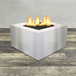 Front view of 36" Square Gravity Stainless Steel Fire Pit by Starfire Designs - Brown with flames on, featuring sleek modern design and durable construction, perfect for outdoor patio spaces. Natural gas or propane compatible, enhancing warmth and ambiance. Lava rocks included for added aesthetic.