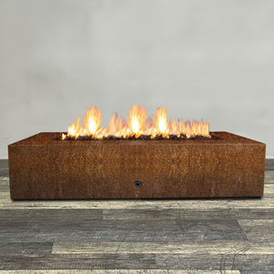 Front view of 72" x 38" Rectangle Gravity Corten Steel Fire Pit by Starfire Designs - Brown with flames on, featuring sleek modern design and durable construction, perfect for outdoor patio spaces. Natural gas or propane compatible, enhancing warmth and ambiance. Lava rocks included for added aesthetic.