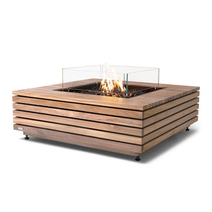 The EcoSmart Fire Base 40 Teak Propane Fire Pit Table showcases a sleek glass wind guard protecting the vibrant propane flames, ensuring safety and enhancing the modern design. Its teak wood slatted exterior offers a durable and stylish finish, perfect for contemporary outdoor spaces. This square gas fire pit is designed for clean-burning flames, making it a great addition to patios, decks, and backyard lounges.