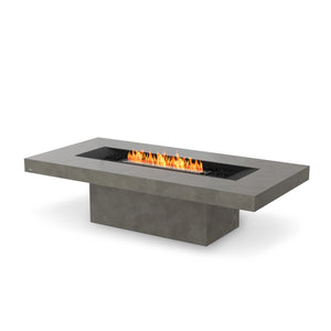 The EcoSmart Fire Gin 90 Chat Height Natural is a modern rectangular fire pit with a smooth concrete finish, designed for both propane and natural gas. Its sleek design features a burner set in a recessed black firebox with decorative black fire media, creating an elegant and functional outdoor heating solution for patios and gardens.