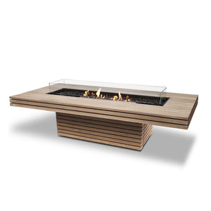 EcoSmart Fire Gin 90 Chat Height Teak outdoor fire pit table with a black burner and wind guard, featuring a luxurious slatted teak wood frame and a rectangular gas fire pit. This modern outdoor fire pit is ideal for backyard spaces, patios, and luxury outdoor living areas.