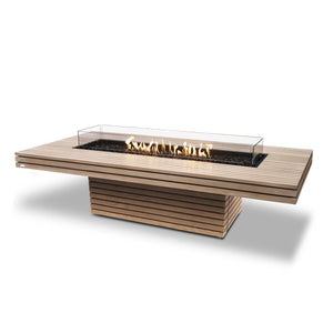 EcoSmart Fire Gin 90 Chat Height Teak propane fire pit table with a sleek slatted teak frame and wind guard, providing a stylish and functional fire feature for outdoor patios, backyards, and modern outdoor seating areas. Runs on propane for easy and efficient heating.
