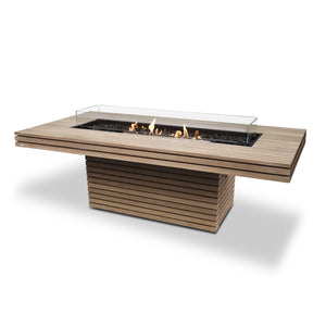The EcoSmart Fire Gin 90 Dining Height Teak rectangular fire table features a contemporary slatted teak wood base and an extended tabletop, offering both function and style. A long stainless steel burner sits at the center, surrounded by a tempered glass fire screen that enhances safety while maintaining visibility of the flames. Designed for outdoor fire pits, this natural gas fire pit brings warmth and ambiance to any outdoor setting.