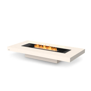 EcoSmart Fire Gin 90 Low Bone outdoor gas fire pit with a black burner, showcasing a sleek rectangular design in a neutral bone finish. Designed for modern outdoor spaces, this luxury fire table offers both style and functionality with an open flame.