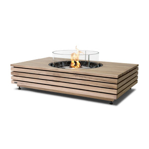 The EcoSmart Fire Martini 50 Teak with a stainless steel burner and wind guard is an elegant outdoor fire table with a natural teak finish. Designed for backyard gatherings, this modern fire pit offers a clean-burning flame, creating a warm and inviting atmosphere. The stainless steel burner ensures durability, making it a perfect addition to luxury outdoor spaces.