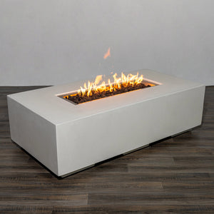 Side view of the Starfire Designs Beton 55" White Rectangle Gas Fire Pit with flames burning over black lava rocks. The long, rectangular burner creates a stunning linear fire effect, enhancing any outdoor ambiance.