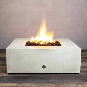 Starfire Designs Gravity 45-inch Square Concrete Gas Fire Pit in white, showcasing a large flame with lava rocks inside the fire bowl, perfect for outdoor patios. Durable and modern in design, this fire pit is ideal for contemporary outdoor spaces. Gas-powered for easy use, providing warmth and ambiance
