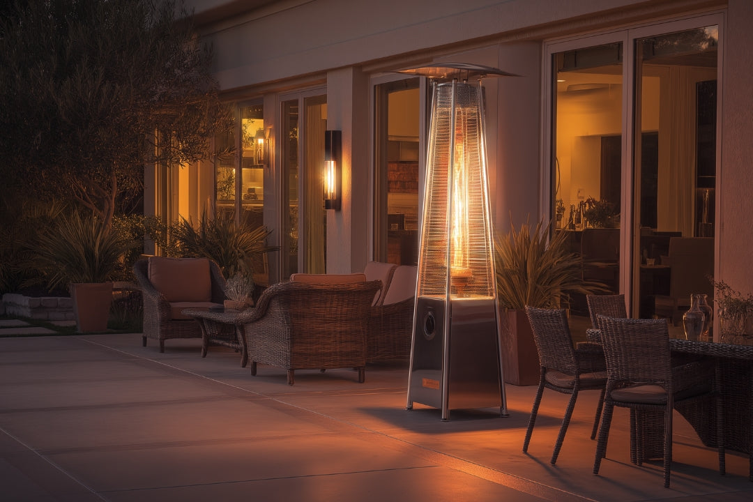 all pyramid-style patio heater glowing at night beside wicker chairs and outdoor seating, creating warmth and ambiance on a modern patio.