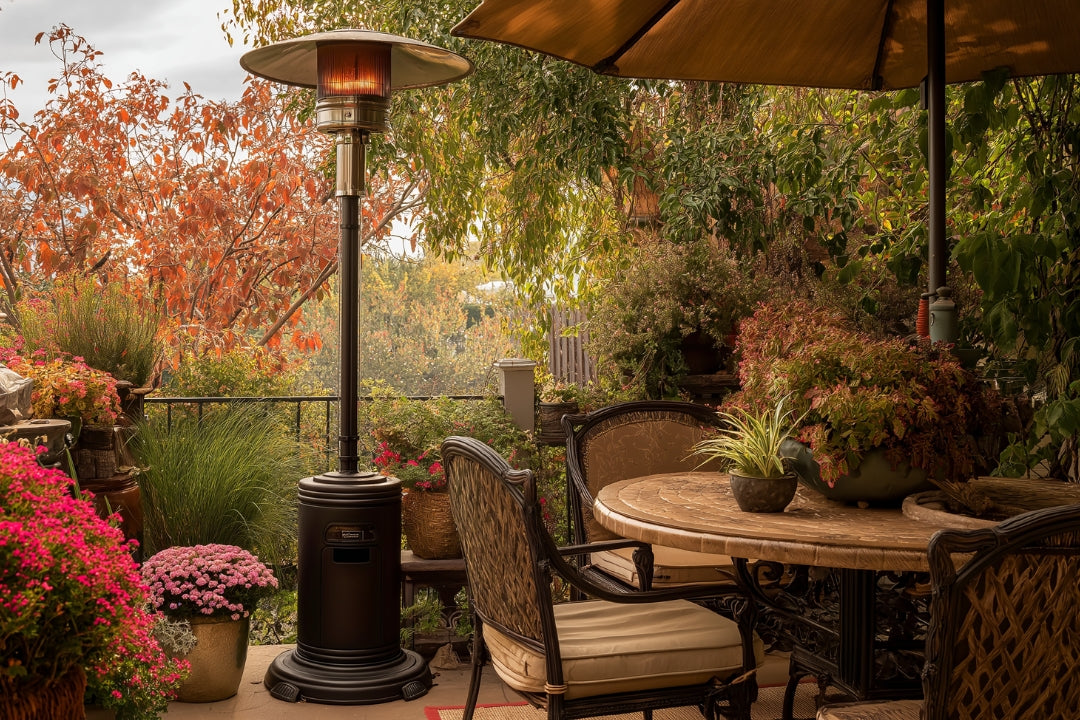 Outdoor patio with a propane patio heater surrounded by lush plants, a round dining table, and fall foliage, creating a warm and cozy atmosphere