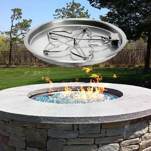 a fire pit burner kit floats above an outdoor DIT fire pit laid with stone