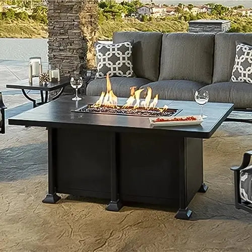 a classic O.W. Lee fire pit table is set with appetizers and ready for guests