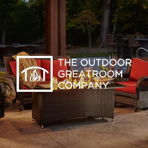 Elegant outdoor setup featuring The Outdoor GreatRoom Company wicker patio furniture with red cushions, centered around a sleek fire pit table with flames, perfect for cozy backyard gatherings.