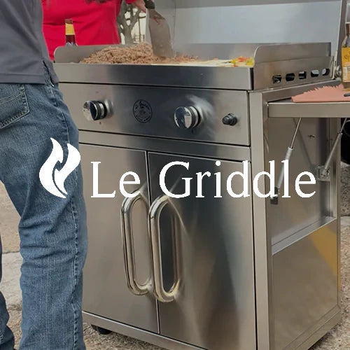 Le Griddle stainless steel outdoor griddle station with dual knobs, side shelves, and a spacious cooking surface, being used for grilling meats and vegetables, ideal for backyard barbecues and outdoor gatherings.