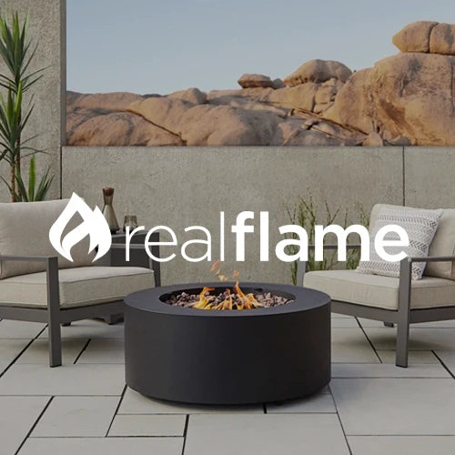 Real Flame outdoor fire pit setup featuring a sleek round black fire pit with a modern design, surrounded by comfortable patio chairs on a tiled deck, offering a cozy ambiance against a rocky desert backdrop.