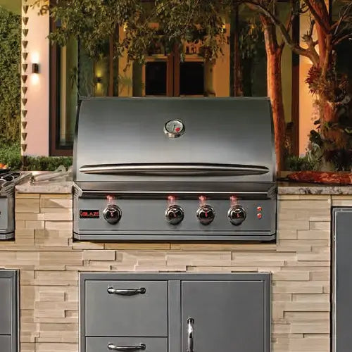 A built-in gas BBQ grill is installed into an outdoor kitchen 