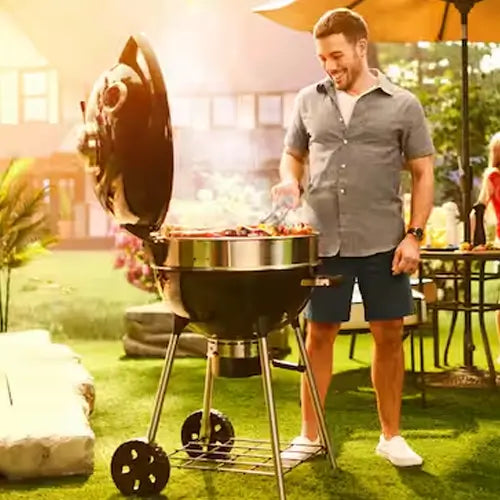 an outdoor charcoal BBQ grill is being cooked on by a dad in the backyard of his home as he is smiling