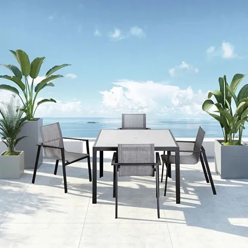 The Harmonia Living Lift Dining Set showcases a modern aluminum frame with mesh-backed chairs and a sleek rectangular table, offering a lightweight yet durable outdoor seating solution.