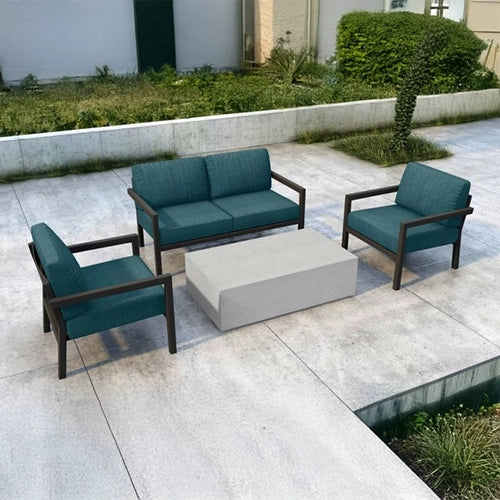 The Harmonia Living Pacifica Deep Seating Set features a contemporary outdoor sofa and two lounge chairs with plush teal cushions, accented by a modern concrete coffee table. 