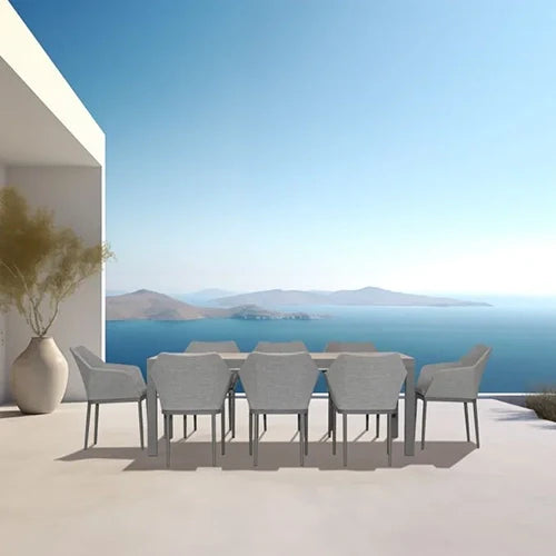 The Harmonia Living Tailor 8-Piece Dining Set features a long contemporary dining table surrounded by sleek upholstered chairs.