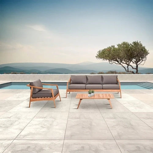 The Harmonia Living Tango Lounge Set includes a mid-century-inspired outdoor sofa, armchair, and coffee table in a natural wood finish. 