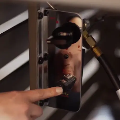 A closeup of the push button ignition system on a fire pit