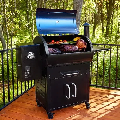 A smoker BBQ grill is open and ready for cooking on the deck of someones patio