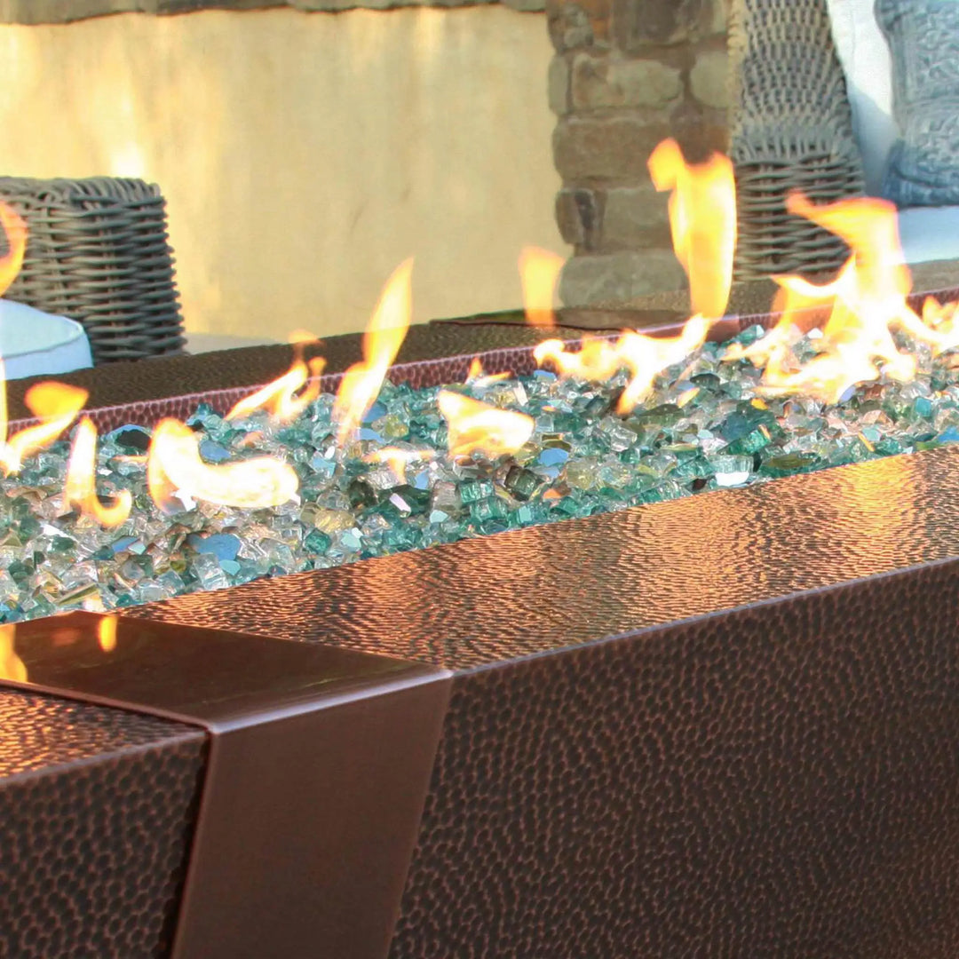 Modern outdoor 10ft Copper Spartan Gas Fire Pit with a sleek hammered copper finish and vibrant flames, perfect for backyard gatherings