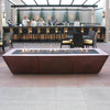 Stylish outdoor bar area featuring the 10ft Copper Spartan Gas Fire Pit, perfect for upscale hospitality venues