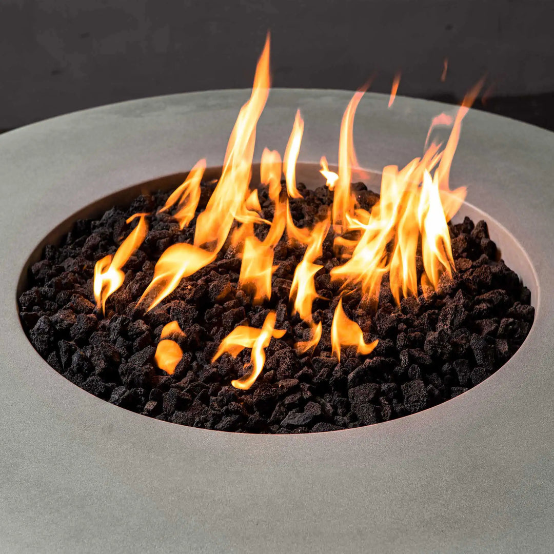 Close-up view of an 18-inch pan and 12-inch ring round stainless steel fire pit burner by Starfire Designs, filled with black lava rocks and producing vibrant flames. Ideal for outdoor fire pits, this durable burner provides efficient heat distribution and enhances your outdoor fire pit experience