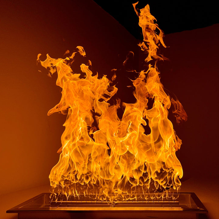 Massive flames erupting from a 30” x 10” rectangle drop-in fire pit pan with a high-output 500K BTU H-burner, creating a bold and dramatic fire display / ideal for large custom fire features needing intense heat and visual impact.