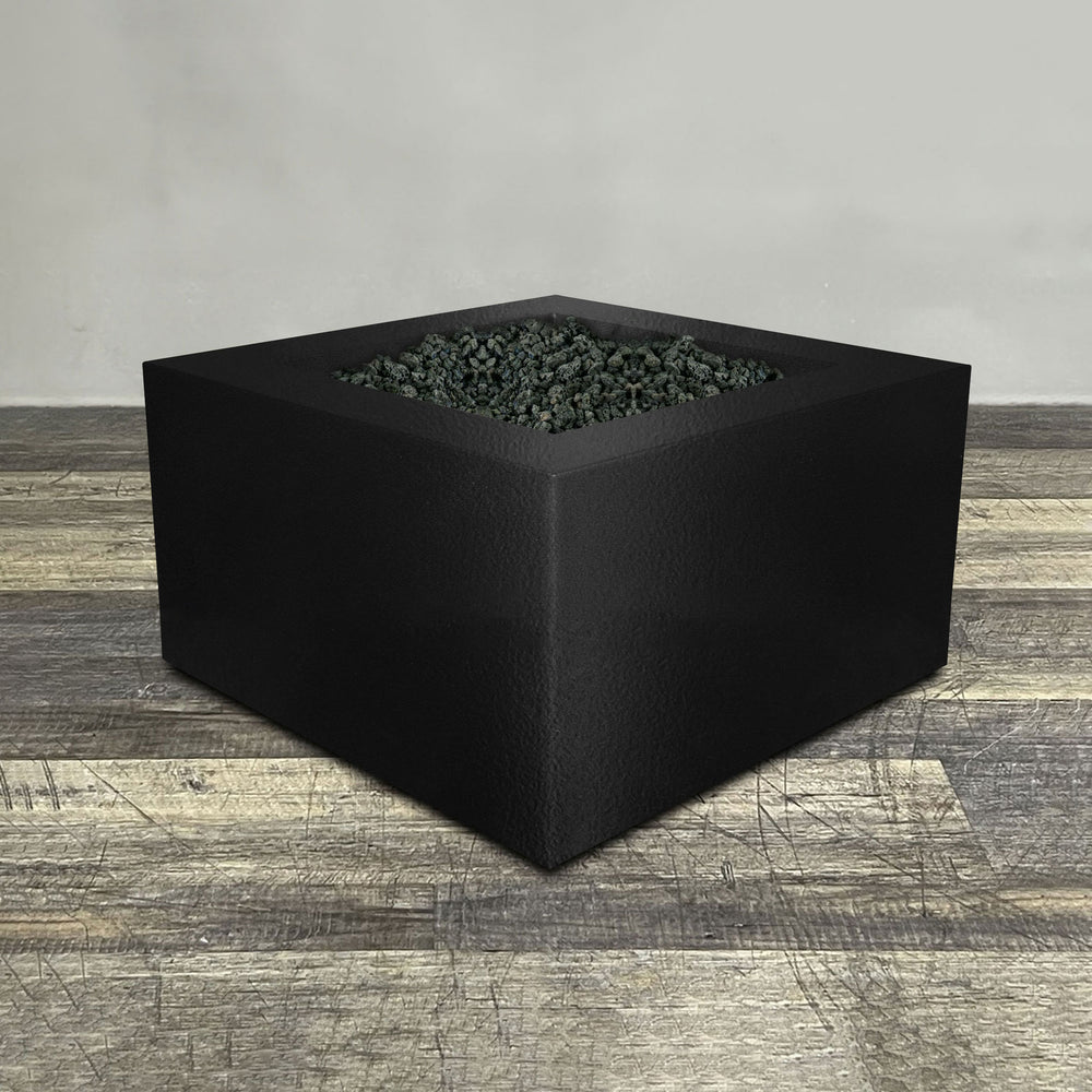 A side view of the 36" Square Gravity Powder Coated Steel Fire Pit - Propane Gas Hardline - Push Button Spark Ignition - Black Hammertone by Starfire Designs - perfect for outdoor patio spaces. Natural gas or propane compatible, enhancing warmth and ambiance. Lava rocks included for added aesthetic.