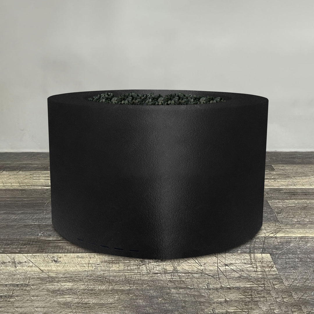 A side view of the 36" Round Gravity Powder Coated Steel Fire Pit - Propane Gas Hardline - Match Lit - Black Hammertone by Starfire Designs - perfect for outdoor patio spaces. Natural gas or propane compatible, enhancing warmth and ambiance. Lava rocks included for added aesthetic.