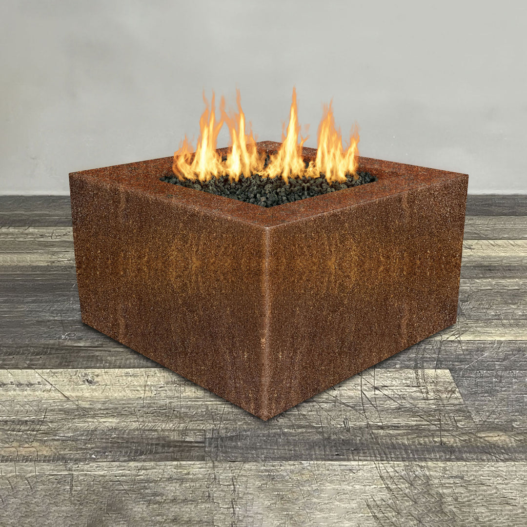 Front view of 36" Square Gravity Corten Steel Fire Pit - Propane Gas Hardline - 110V CSA Hi/Lo Electronic Ignition System w/Bluetooth & Handheld Remote by Starfire Designs - Brown with flames on, featuring sleek modern concrete design and durable construction, perfect for outdoor patio spaces. Natural gas or propane compatible, enhancing warmth and ambiance. Lava rocks included for added aesthetic.