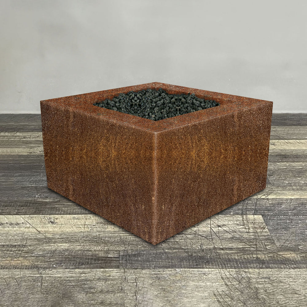 A side view of the 36" Square Gravity Corten Steel Fire Pit - Propane Gas Hardline - 110V CSA Hi/Lo Electronic Ignition System w/Bluetooth & Handheld Remote by Starfire Designs - perfect for outdoor patio spaces. Natural gas or propane compatible, enhancing warmth and ambiance. Lava rocks included for added aesthetic.