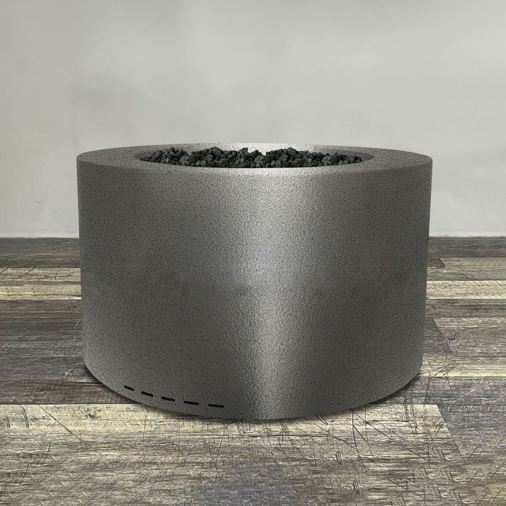 A side view of the 36" Round Gravity Powder Coated Steel Fire Pit - Natural Gas - Match Lit - Silver Hammertone by Starfire Designs - perfect for outdoor patio spaces. Natural gas or propane compatible, enhancing warmth and ambiance. Lava rocks included for added aesthetic.