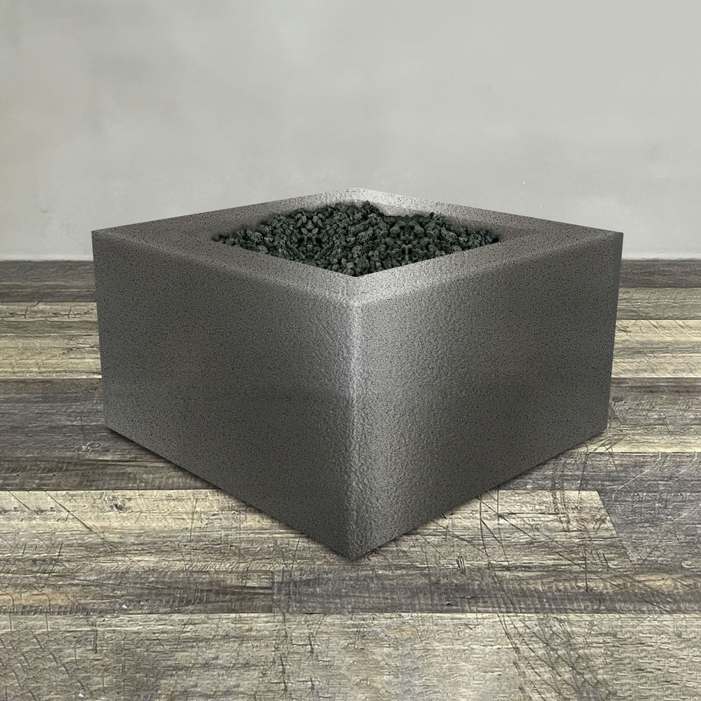 A side view of the 36" Square Gravity Powder Coated Steel Fire Pit - Propane Gas Hardline - Flame Sense with Spark Ignition System - Silver Hammertone by Starfire Designs - perfect for outdoor patio spaces. Natural gas or propane compatible, enhancing warmth and ambiance. Lava rocks included for added aesthetic.