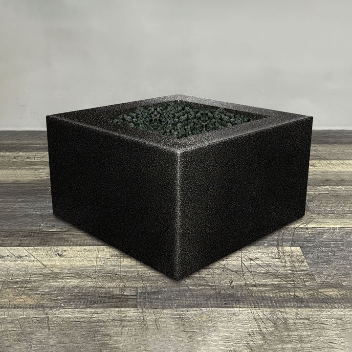 A side view of the 36" Square Gravity Powder Coated Steel Fire Pit - Propane Gas Hardline - Flame Sense with Spark Ignition System - Silver Vein by Starfire Designs - perfect for outdoor patio spaces. Natural gas or propane compatible, enhancing warmth and ambiance. Lava rocks included for added aesthetic.