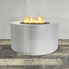 A side view of the 36" Round Gravity Stainless Steel Fire Pit by Starfire Designs - perfect for outdoor patio spaces. Natural gas or propane compatible, enhancing warmth and ambiance. Lava rocks included for added aesthetic.