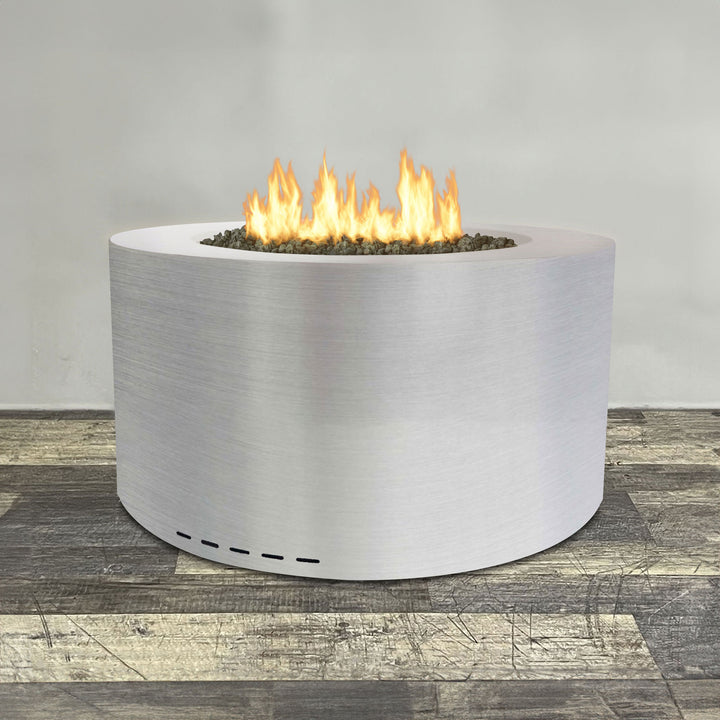 A side view of the 36" Round Gravity Stainless Steel Fire Pit by Starfire Designs - perfect for outdoor patio spaces. Natural gas or propane compatible, enhancing warmth and ambiance. Lava rocks included for added aesthetic.