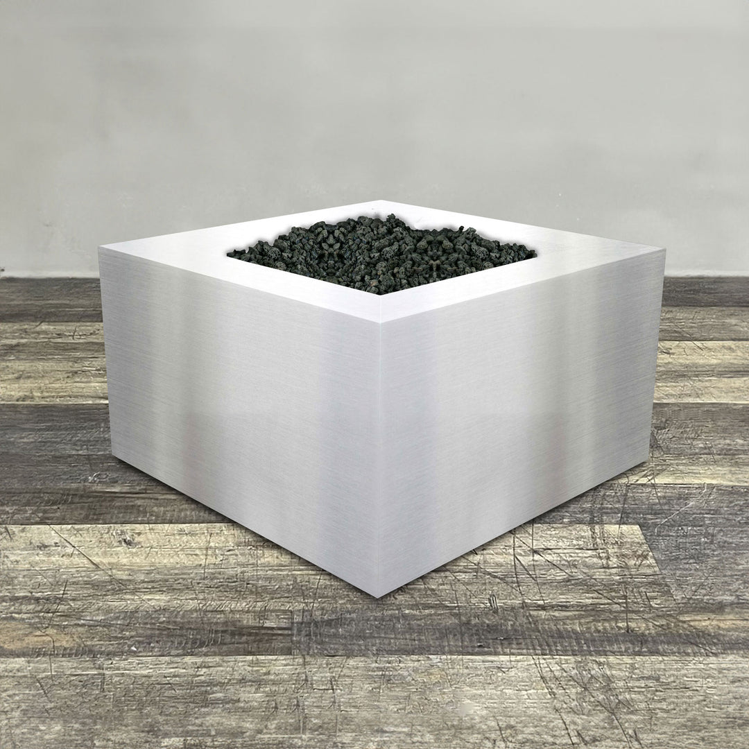 A side view of the 36" Square Gravity Stainless Steel Fire Pit by Starfire Designs - perfect for outdoor patio spaces. Natural gas or propane compatible, enhancing warmth and ambiance. Lava rocks included for added aesthetic.