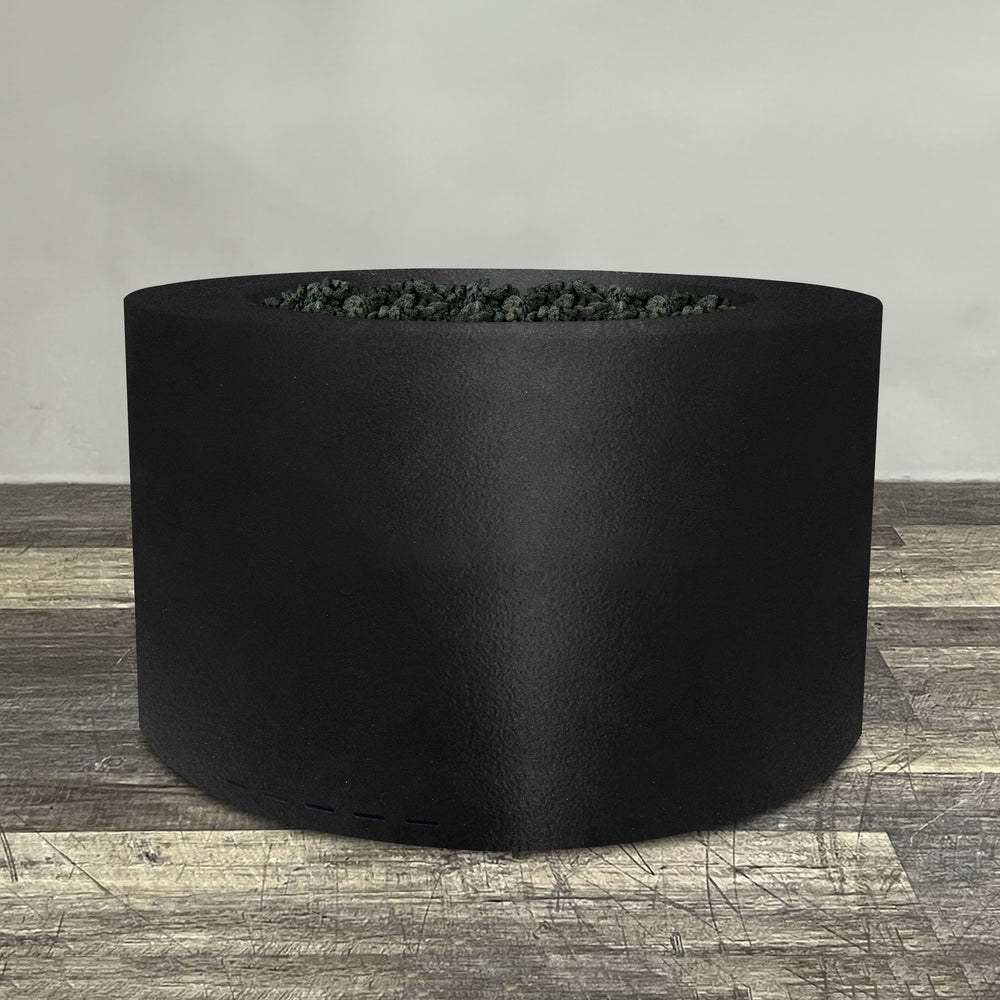 A side view of the 45" Round Gravity Powder Coated Steel Fire Pit - Natural Gas - 110V CSA On/Off Electronic Ignition System - Black Hammertone by Starfire Designs - perfect for outdoor patio spaces. Natural gas or propane compatible, enhancing warmth and ambiance. Lava rocks included for added aesthetic.