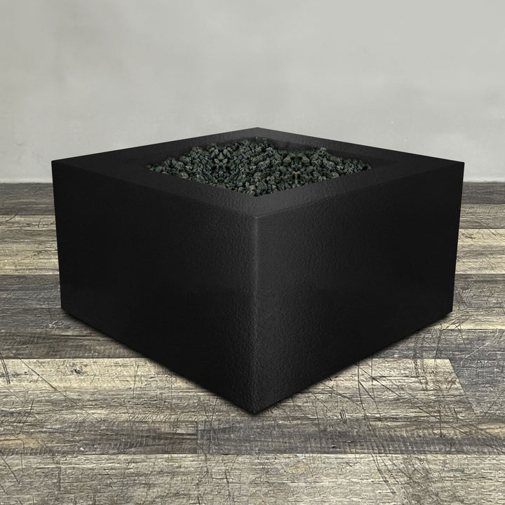 A side view of the 45" Square Gravity Powder Coated Steel Fire Pit - Natural Gas - 110V Electronic Ignition System - Black Hammertone by Starfire Designs - perfect for outdoor patio spaces. Natural gas or propane compatible, enhancing warmth and ambiance. Lava rocks included for added aesthetic.