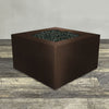 A side view of the 45" Square Gravity Powder Coated Steel Fire Pit - Natural Gas - 110V Electronic Ignition System - Bronze Hammertone by Starfire Designs - perfect for outdoor patio spaces. Natural gas or propane compatible, enhancing warmth and ambiance. Lava rocks included for added aesthetic.