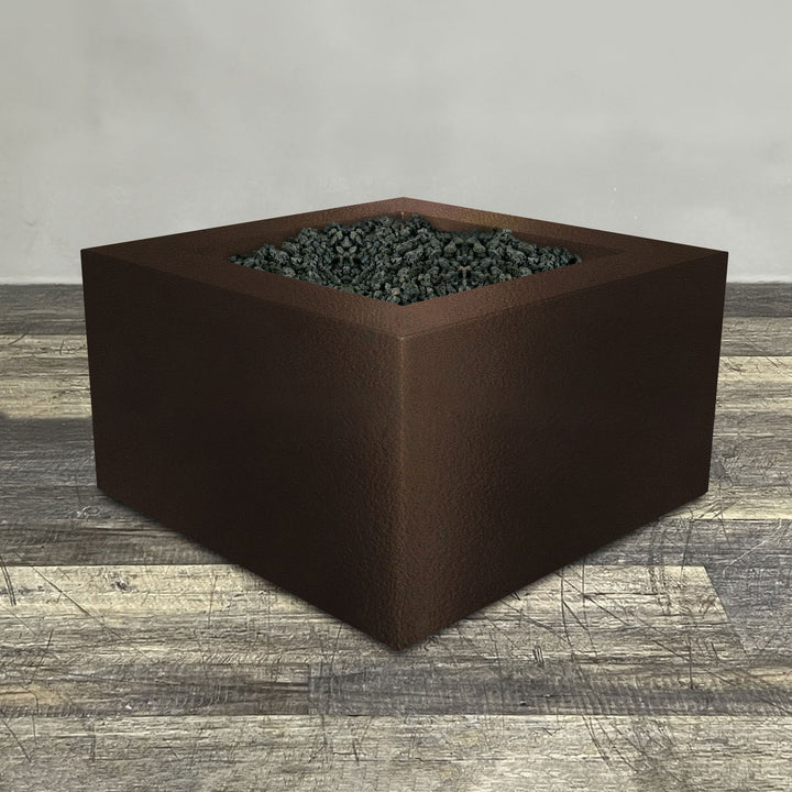 A side view of the 45" Square Gravity Powder Coated Steel Fire Pit - Natural Gas - 110V Electronic Ignition System - Bronze Hammertone by Starfire Designs - perfect for outdoor patio spaces. Natural gas or propane compatible, enhancing warmth and ambiance. Lava rocks included for added aesthetic.
