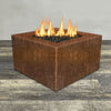 Front view of 45" Square Gravity Corten Steel Fire Pit by Starfire Designs - Brown with flames on, featuring sleek modern  design and durable construction, perfect for outdoor patio spaces. Natural gas or propane compatible, enhancing warmth and ambiance. Lava rocks included for added aesthetic.