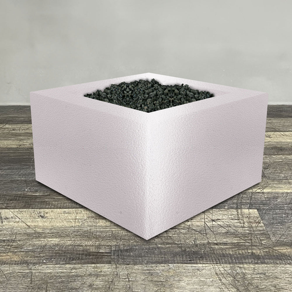 A side view of the 45" Square Gravity Powder Coated Steel Fire Pit - Natural Gas - 110V Electronic Ignition System - White Hammertone by Starfire Designs - perfect for outdoor patio spaces. Natural gas or propane compatible, enhancing warmth and ambiance. Lava rocks included for added aesthetic.