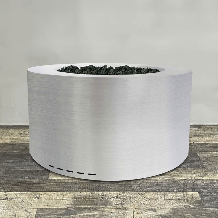 A side view of the 45" Round Gravity Stainless Steel Fire Pit by Starfire Designs - perfect for outdoor patio spaces. Natural gas or propane compatible, enhancing warmth and ambiance. Lava rocks included for added aesthetic.