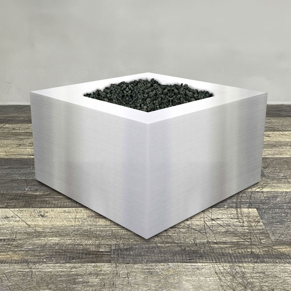 A side view of the 45" Square Gravity Stainless Steel Fire Pit by Starfire Designs - perfect for outdoor patio spaces. Natural gas or propane compatible, enhancing warmth and ambiance. Lava rocks included for added aesthetic.