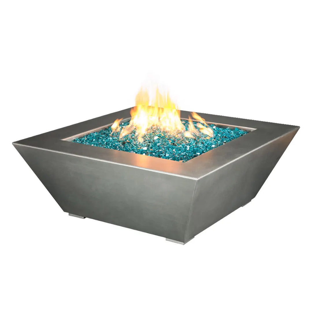 Modern square fire pit with a sleek stainless steel finish, featuring a 48-inch body filled with turquoise fire glass, emitting a warm and vibrant flame